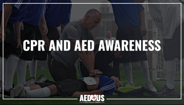 Coach performing CPR on unresponsive young athlete on the soccer field with an AED Plus and electrodes.