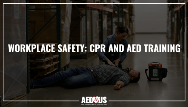 Bystander is checking unresponsive person on a warehouse floor with a Cardiac Science G5 AED beside them.